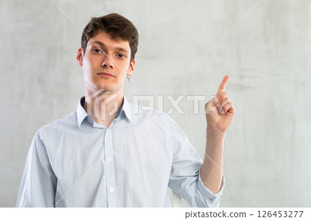 Portrait of young guy gesturing in studio Portrait of young guy gesturing in studio 126453277