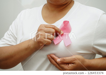 Asian woman with pink ribbon, World Breast Cancer Day at October. Asian woman with pink ribbon, World Breast Cancer Day at October. 126453374