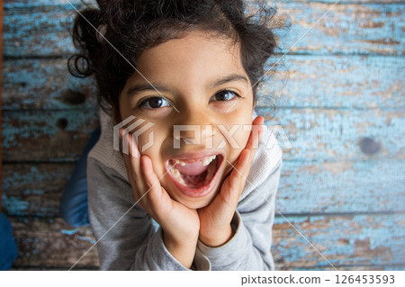 Little girl happy to show her first fallen tooth 126453593