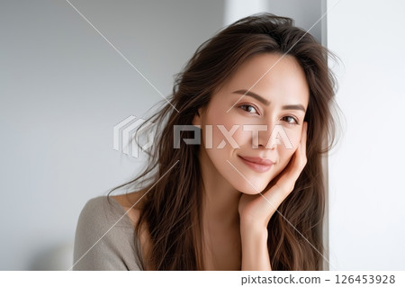 Serene Young Woman Portrait Soft Natural Light Neutral Background Serene Young Woman Portrait Soft Natural Light Neutral Background 126453928
