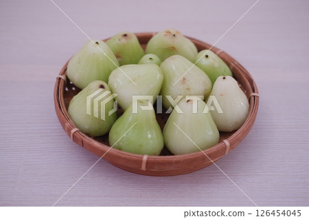 Rose Apple in a Woven Basket on a Wooden Mat Rose Apple in a Woven Basket on a Wooden Mat 126454045