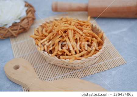 Pile of Crispy Fried Snack Sticks in a Woven Basket Pile of Crispy Fried Snack Sticks in a Woven Basket 126454062