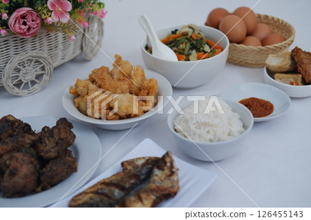 A Complete Indonesian Meal Rice, Fried Chicken, Vegetables and Eggs 126455143