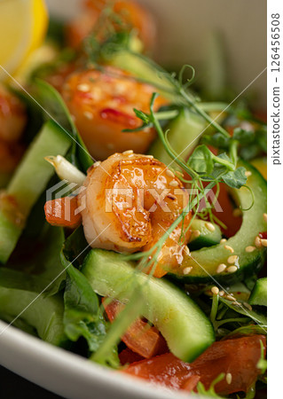 Portion of salad with fresh vegetables and shrimp 126456508