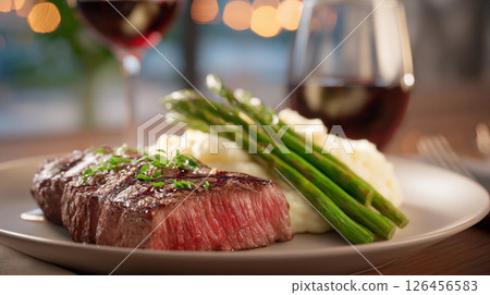 delicious juicy beef steak with garnish and asparagus in a restaurant 126456583
