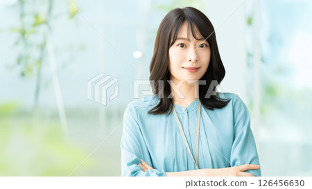 Smiling woman with folded arms, businesswoman Smiling woman with folded arms, businesswoman 126456630