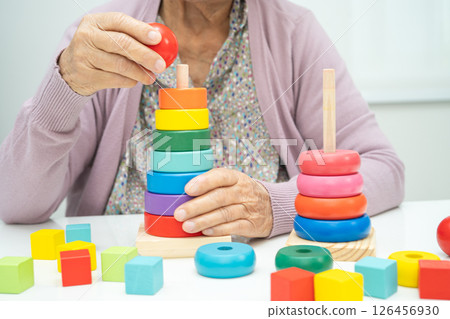 Asian elderly woman patient suffering from dementia learn practical motor skills rehabilitation. 126456930