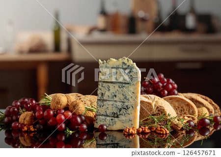 Gorgonzola with ciabatta, walnuts, and grapes on a kitchen table. Gorgonzola with ciabatta, walnuts, and grapes on a kitchen table. 126457671