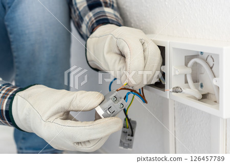 Electrician at work on a residential electrical system. Electricity. 126457789