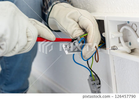 Electrician at work on a residential electrical system. Electricity. Electrician at work on a residential electrical system. Electricity. 126457790
