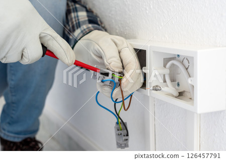 Electrician at work on a residential electrical system. Electricity. 126457791