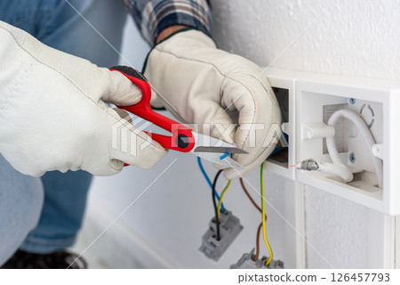 Electrician at work on a residential electrical system. Electricity. 126457793