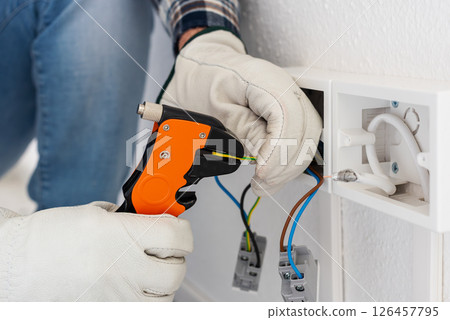 Electrician at work on a residential electrical system. Electricity. Electrician at work on a residential electrical system. Electricity. 126457795