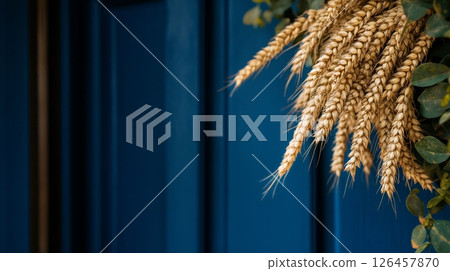 Wheat Bouquet Arranged Against a Blue Wall Brings a Rustic Charm to the Environment 126457870