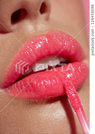 Bright Pink Lip Gloss Application With Glossy Finish and Defined Lips Bright Pink Lip Gloss Application With Glossy Finish and Defined Lips 126458086