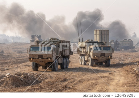 Military vehicles maneuver through a smoke-filled battlefield during a conflict situation in a desert environment. 126459293