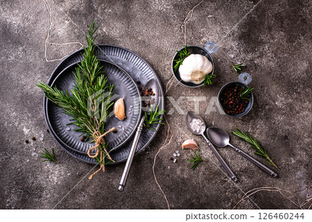 Rosemary, garlic, salt and pepper. 126460244