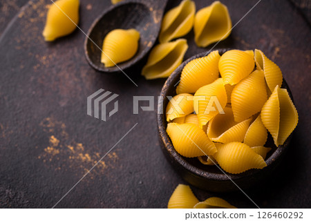Raw pasta in shape of shells Raw pasta in shape of shells 126460292