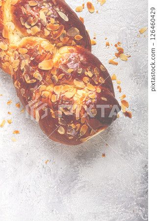 braided, sweet bread pie, with sliced almonds, breakfast, braided bread, brioche, on a light background, top view, no people, braided, sweet bread pie, with sliced almonds, breakfast, braided bread, brioche, on a light background, top view, no people, 126460429