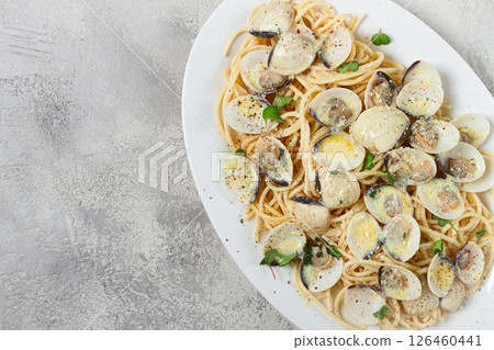 spaghetti with vongole clams, in cream sauce, carbonara, on a white plate, homemade, top view, no people, 126460441