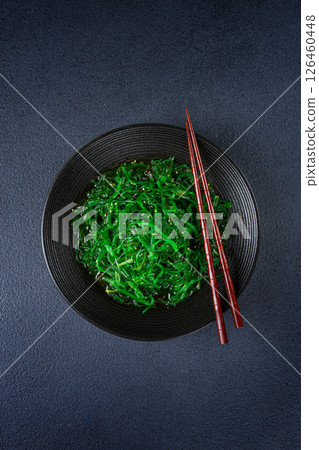 Chuka salad, made from fresh seaweed, with sesame dressing, served in a black bowl, with chopsticks, 126460448