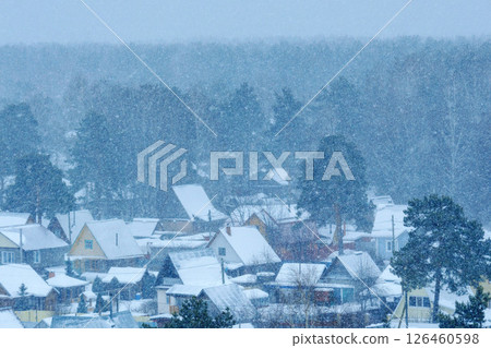 Snowfall blankets a quiet village in the winter season, creating a serene atmosphere and enchanting landscape Snowfall blankets a quiet village in the winter season, creating a serene atmosphere and enchanting landscape 126460598