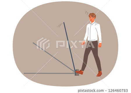 Business man steps on rake, risking injury, for concept of bankruptcy due to mistake 126460783