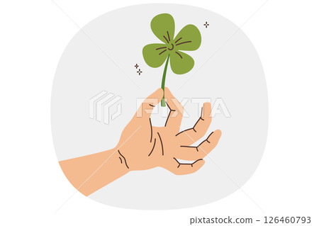 Clover in hand of man who picked plant and made wish to achieve good luck and fortune 126460793