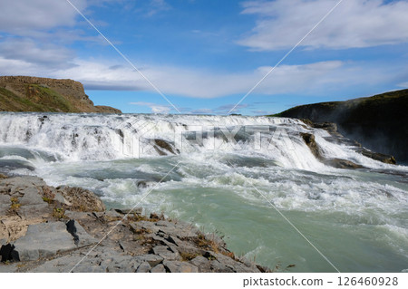 View of the waterfall from the rocky shore 126460928