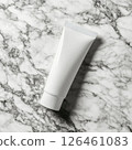 A photo of a body cream tube mockup on smooth marble. The high detail, soft shadows, and bright clean atmosphere create an elegant and modern aesthetic, perfect for skincare product presentation. 126461083