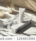 A photo of a body cream tube mockup on smooth marble. The high detail, soft shadows, and bright clean atmosphere create an elegant and modern aesthetic, perfect for skincare product presentation. 126461084