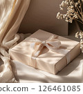 Photo of a gift box mockup adorned with a bow on a neutral surface, featuring soft focus and a warm color palette, creating an elegant and inviting mood 126461085