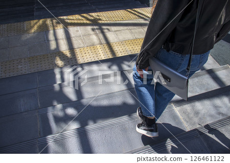Woman walking down the stairs Woman walking down the stairs 126461122