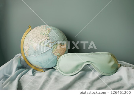 globe and sleep mask on bed, world sleep day 126461200