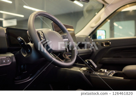 Closeup of a modern car steering wheel with control buttons for technology and convenience 126461820