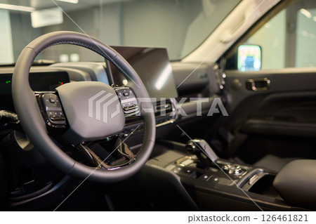Closeup of a modern car steering wheel with control buttons for technology and convenience 126461821