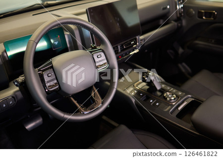 Closeup of a modern car steering wheel with control buttons for technology and convenience Closeup of a modern car steering wheel with control buttons for technology and convenience 126461822