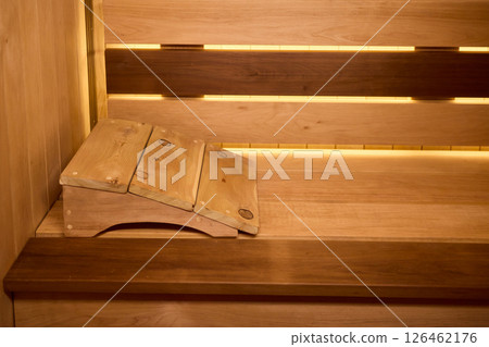 Experience the Cozy Wooden Sauna Interior Equipped with Inviting Warm Lighting and Ambiance Experience the Cozy Wooden Sauna Interior Equipped with Inviting Warm Lighting and Ambiance 126462176