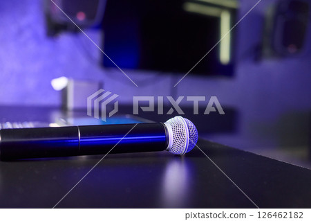 There are several colorful microphones beautifully arranged on a table in a trendy karaoke room There are several colorful microphones beautifully arranged on a table in a trendy karaoke room 126462182