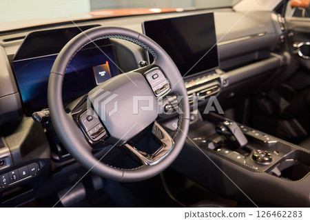 Closeup of a modern car steering wheel with control buttons for technology and convenience 126462283