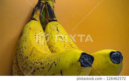Close-Up of Ripe Bananas on Yellow Background: Minimalist Food Concept 126462572
