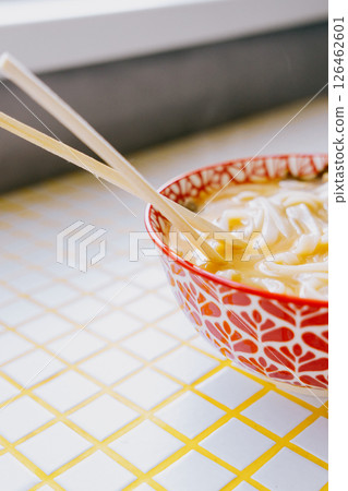 plate of noodles and chopsticks. vegetable ramen in a bright blue plate. Asian dishes. 126462601