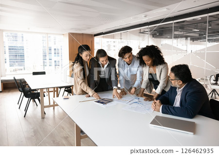 Five professionals engaged in collaboration, problem-solving in modern office Five professionals engaged in collaboration, problem-solving in modern office 126462935