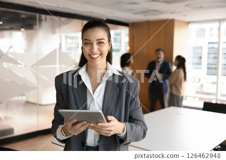 Portrait of corporate trainer posing in boardroom with digital tablet Portrait of corporate trainer posing in boardroom with digital tablet 126462948
