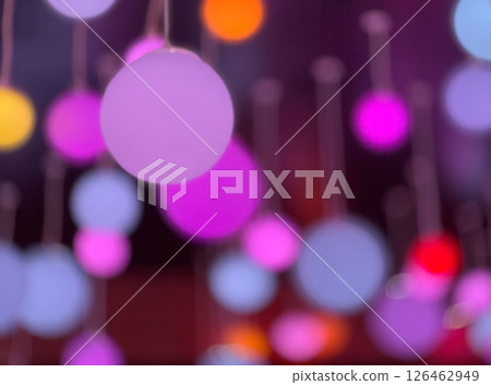 Vibrant glowing orbs suspended in dark ambient space creating dreamy abstract effect 126462949