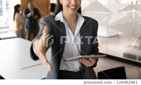 Smiling businesswoman extending her hand for handshake, closeup cropped view Smiling businesswoman extending her hand for handshake, closeup cropped view 126462961
