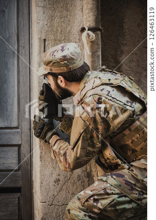 Soldier Communicates With Walkie Talkie Before Going Into A House 126463119