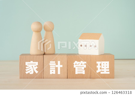 Blocks with the words "household management" written on them, dolls, and a model house Blocks with the words "household management" written on them, dolls, and a model house 126463318