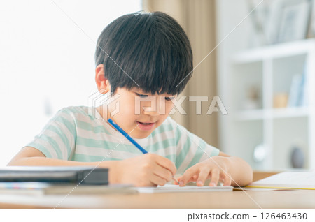 A boy studying in the living room 126463430