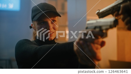 Female Secret Agent Pointing the Gun at Unrecognizable Opponent, Talking to Killer 126463641